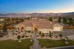 Experience luxury living in this stunning single-story home, boasting a tile roof and a charming stone-accented facade.