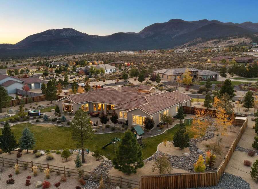 Experience luxury living in this stunning single-story home, nestled against a breathtaking mountain backdrop.