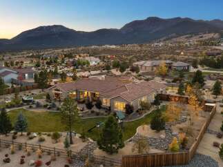 Experience luxury living in this stunning single-story home, nestled against a breathtaking mountain backdrop.