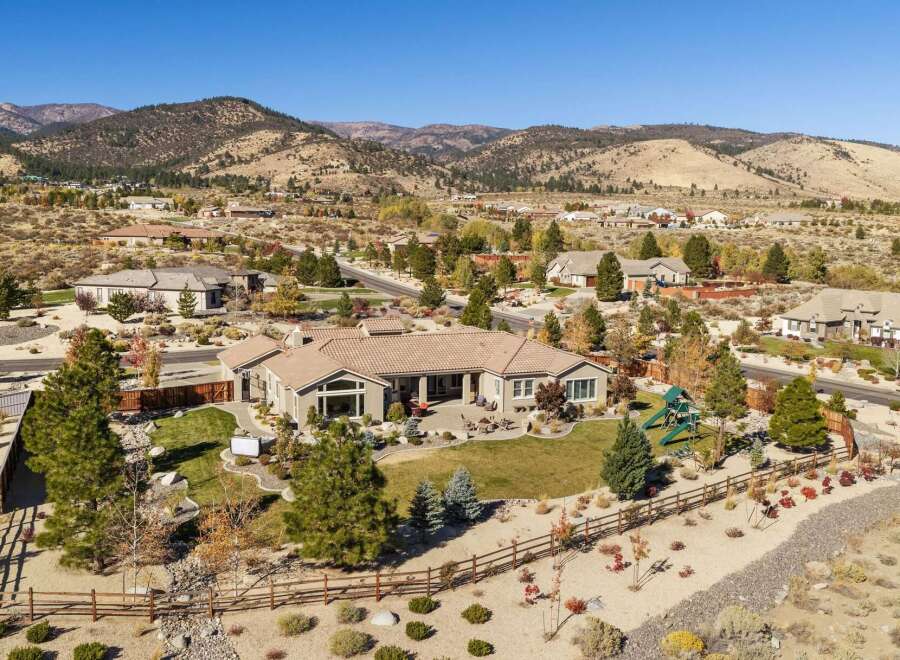 Experience luxury living in this stunning single-story home, nestled against a backdrop of majestic mountains.