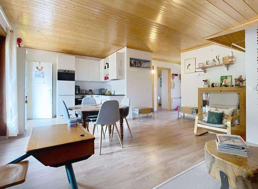 Step into this charming and inviting living space, featuring a beautifully appointed kitchen with sleek white cabinetry and modern appliances.