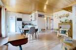 Step into this charming and inviting living space, featuring a beautifully appointed kitchen with sleek white cabinetry and modern appliances.