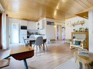 Step into this charming and inviting living space, featuring a beautifully appointed kitchen with sleek white cabinetry and modern appliances.