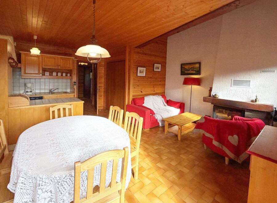 Experience cozy living in this charming wooden cabin, featuring a well-equipped kitchen and a spacious dining area perfect for family gatherings.