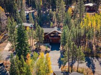 Nestled amidst a vibrant autumn forest, this stunning mountain home offers an idyllic retreat.