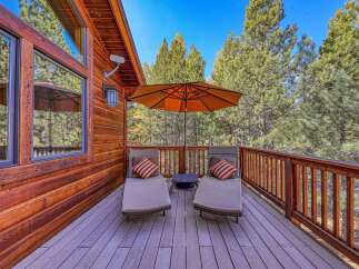Enjoy the serene mountain views from this spacious wooden deck, perfect for relaxing or entertaining.