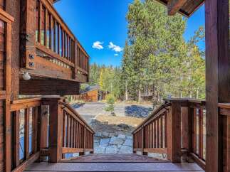 Experience the charm of this rustic mountain retreat, featuring expansive wooden decks and balconies perfect for enjoying the crisp alpine air.