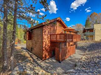 Experience the charm of this rustic wooden home, featuring a spacious deck perfect for outdoor relaxation and entertaining.