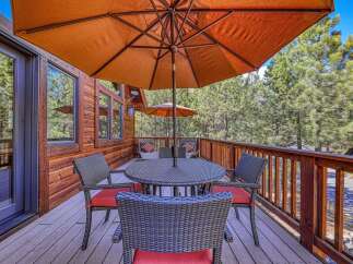 Enjoy outdoor living on this spacious wooden deck, perfect for al fresco dining or relaxing amidst nature.
