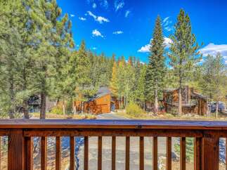 Nestled amidst towering pine trees and vibrant autumn foliage, this property offers a serene mountain retreat.