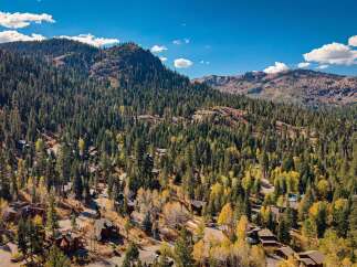 Nestled amidst a dense forest of pine and aspen trees, this property offers a serene mountain retreat.