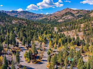 Discover this stunning mountain retreat nestled amongst towering pine trees and vibrant autumn foliage.