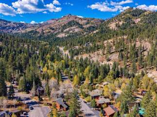 Nestled amidst a vibrant autumn forest, this property offers a serene mountain escape.