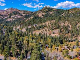 Nestled amidst a vibrant autumn forest, this property offers a serene mountain retreat.
