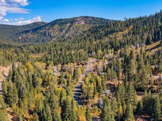 Nestled amidst a vibrant autumn forest, this property offers a serene mountain retreat.