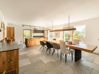 Experience the perfect blend of rustic charm and modern luxury in this open-concept kitchen and dining area.