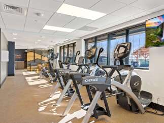 Step into this modern fitness center, equipped with top-of-the-line Cybex Arc Trainers and other cardio machines to elevate your workout routine.