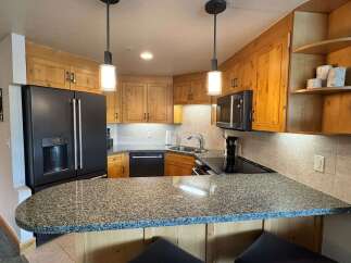 This kitchen boasts beautiful natural wood cabinetry, offering a warm and inviting aesthetic.