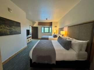 Experience comfort and style in this beautifully appointed hotel room, featuring two queen-sized beds perfect for families or groups.