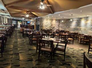 Experience dining in a rustic yet elegant atmosphere with this spacious restaurant interior.