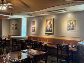 Experience rustic elegance in this dining space, featuring warm wood tables and plush leather seating perfect for intimate gatherings.