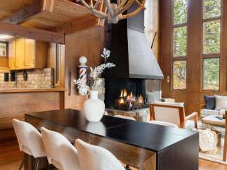 Experience rustic charm and modern comfort in this inviting living space, featuring a grand stone fireplace as the centerpiece.