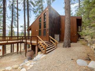 Experience the ultimate mountain retreat in this stunning wooden A-frame home, nestled amongst towering pine trees.