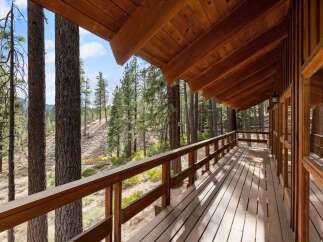 Experience the serene beauty of nature from this expansive wooden deck, perfect for enjoying your morning coffee or evening sunsets.