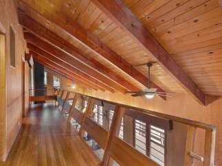 Experience the warmth and natural beauty of this home, featuring a stunning vaulted wood-paneled ceiling with exposed beams that create a sense of spaciousness and architectural interest.