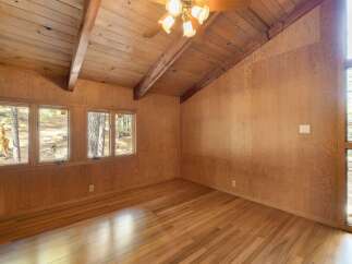 This room features a stunning vaulted wood-paneled ceiling with exposed beams, creating a warm and rustic ambiance.
