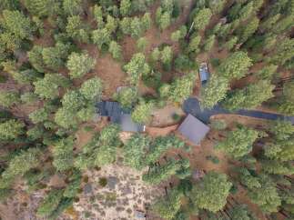 Discover this secluded property nestled within a dense forest, offering a unique blend of natural beauty and modern living.