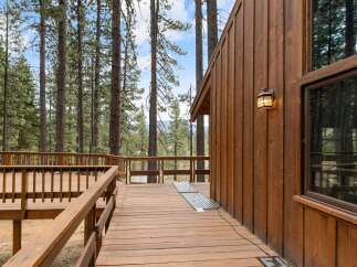 Experience the serene beauty of nature from this expansive wooden deck, perfect for outdoor living and entertaining.
