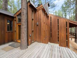 Experience unique architecture seamlessly integrated with nature in this stunning wooden home.