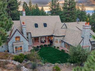 Experience luxury mountain living in this stunning estate, nestled amidst towering pine trees.
