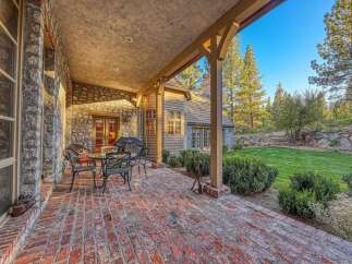 Enjoy outdoor living on this charming brick patio, complete with a dining set and a grill, perfect for entertaining.