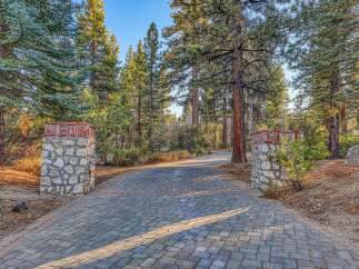 Welcome to this stunning property, accessed via a beautifully paved driveway lined with majestic pine trees.