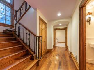 Step into luxury with this stunning staircase featuring rich hardwood treads and elegant wrought iron railings.