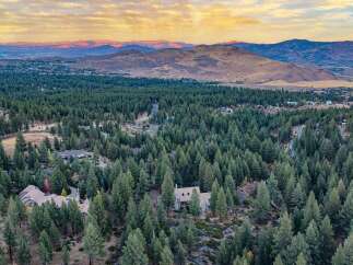Nestled amidst a dense forest of mature pine trees, this stunning property offers unparalleled privacy and a serene natural setting.
