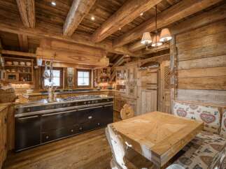Experience rustic charm in this beautifully crafted wooden kitchen, featuring a professional-grade range and ample storage.