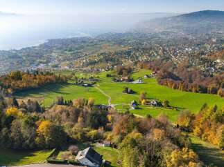 Experience breathtaking panoramic views of a serene lake and rolling hills from this stunning property.