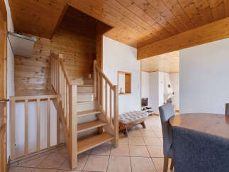 Step into this charming home featuring a beautiful wooden staircase that leads to the upper level.
