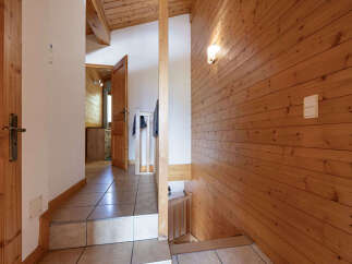 Step into a charming chalet-style interior featuring warm wooden paneling throughout.