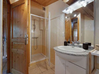 This charming bathroom features a spacious walk-in shower with a glass enclosure, perfect for a refreshing start to your day.