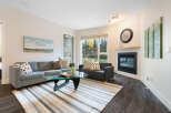 Cozy living room featuring a comfortable grey sectional sofa and a dark sofa, perfect for relaxation.