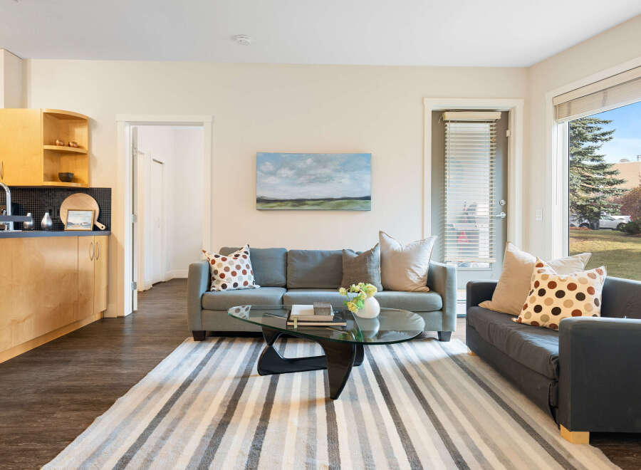 Experience comfortable living in this spacious apartment featuring a modern kitchen with ample cabinet space and a sleek countertop.