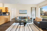 Experience comfortable living in this spacious apartment featuring a modern kitchen with ample cabinet space and a sleek countertop.
