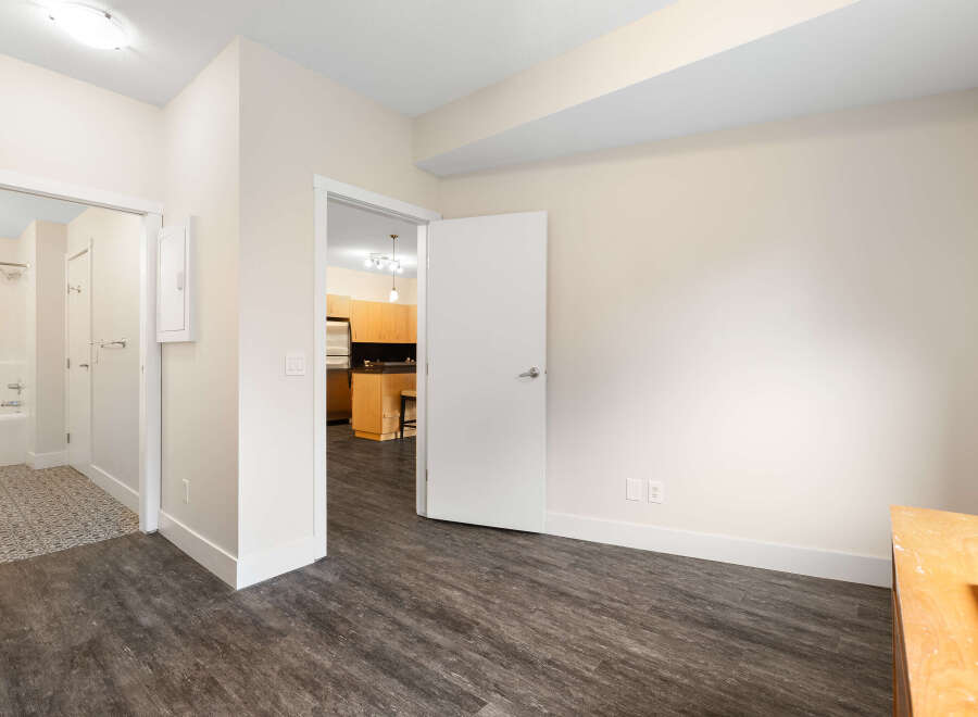 Step into this bright and airy living space, featuring elegant dark wood-look flooring that complements the neutral walls.
