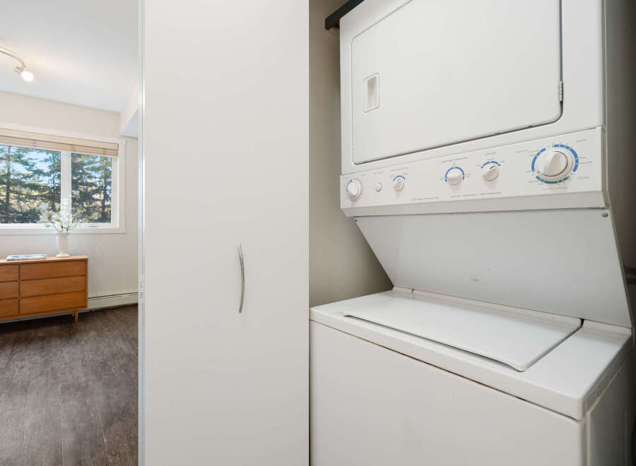This laundry area features a Frigidaire stacked washer and dryer combo, perfect for maximizing space in your home.