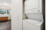 This laundry area features a Frigidaire stacked washer and dryer combo, perfect for maximizing space in your home.