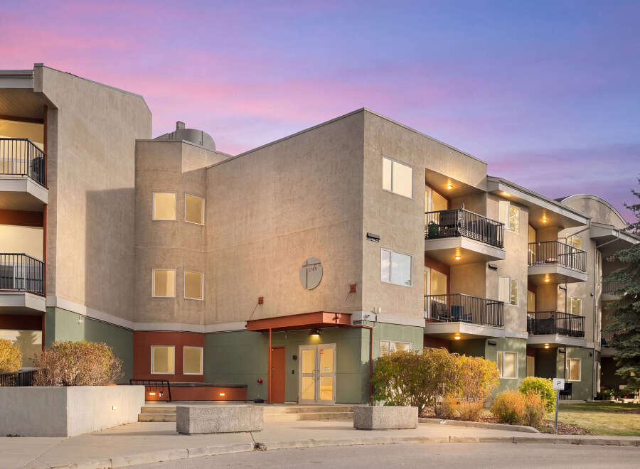 Experience modern living in this stunning apartment building, featuring spacious balconies perfect for enjoying the twilight sky.